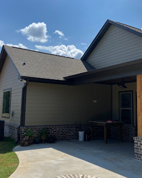 Home with new charcoal seamless gutters in central Mississippi