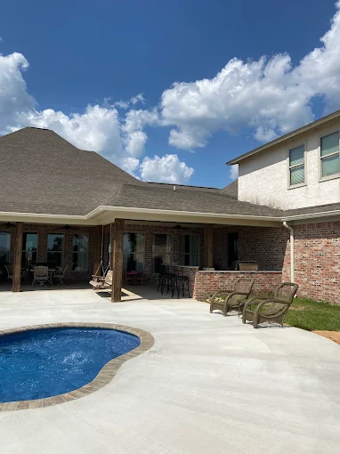 Brick home with seamless gutters wrapping covered patio